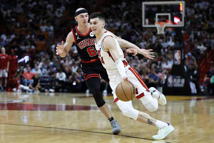 Miami Heat guard Tyler Herro (14) dribbles the basketball ahead of Chicago Bulls guard Alex Caruso (6)